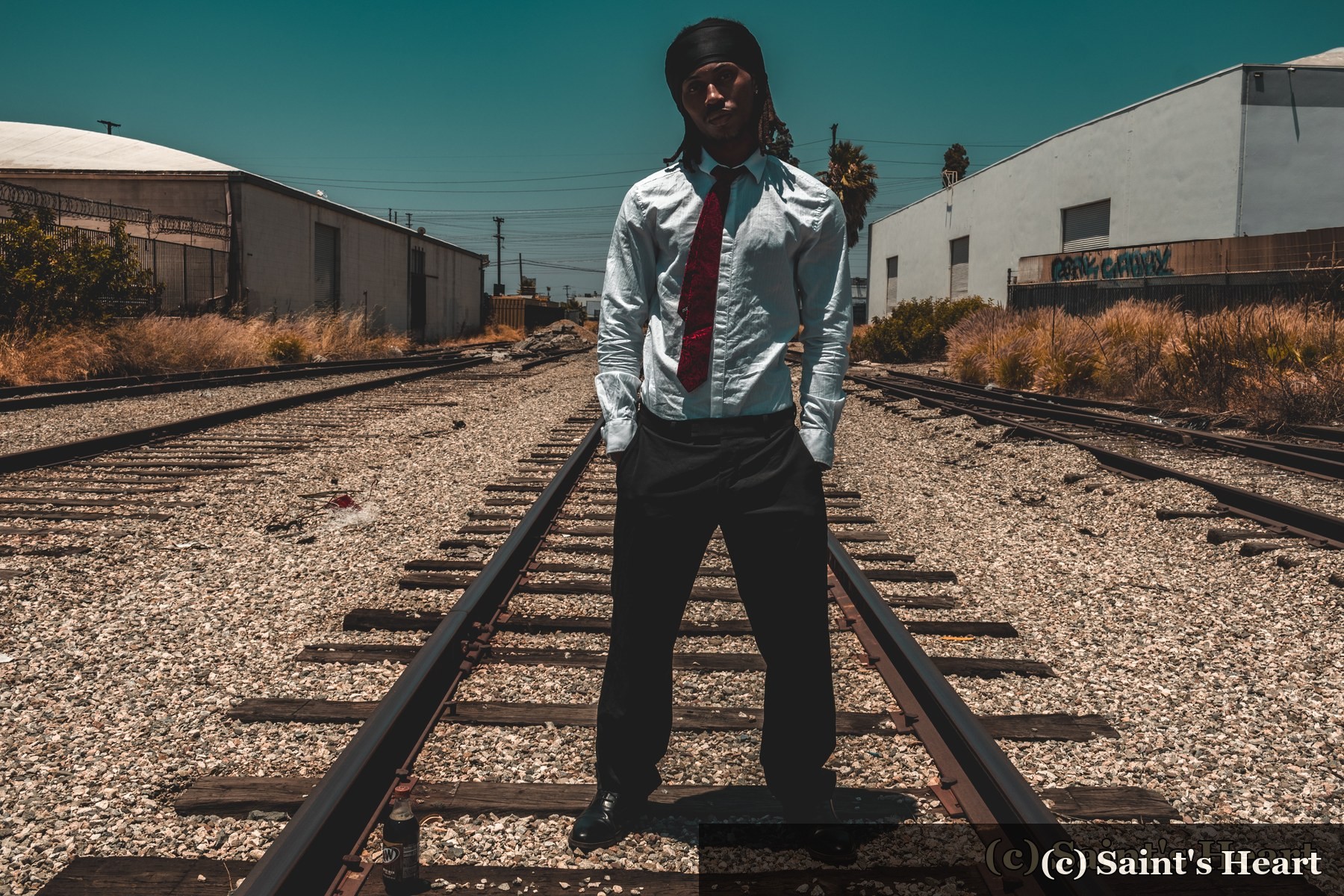 Solo portrait standing on railway tracks